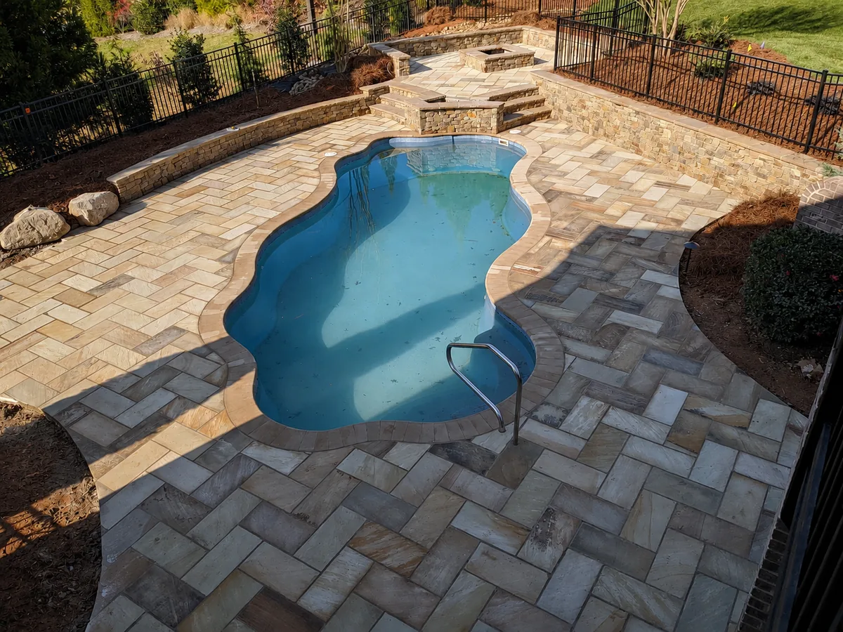 Stone and paver hardscape around an outdoor pool area